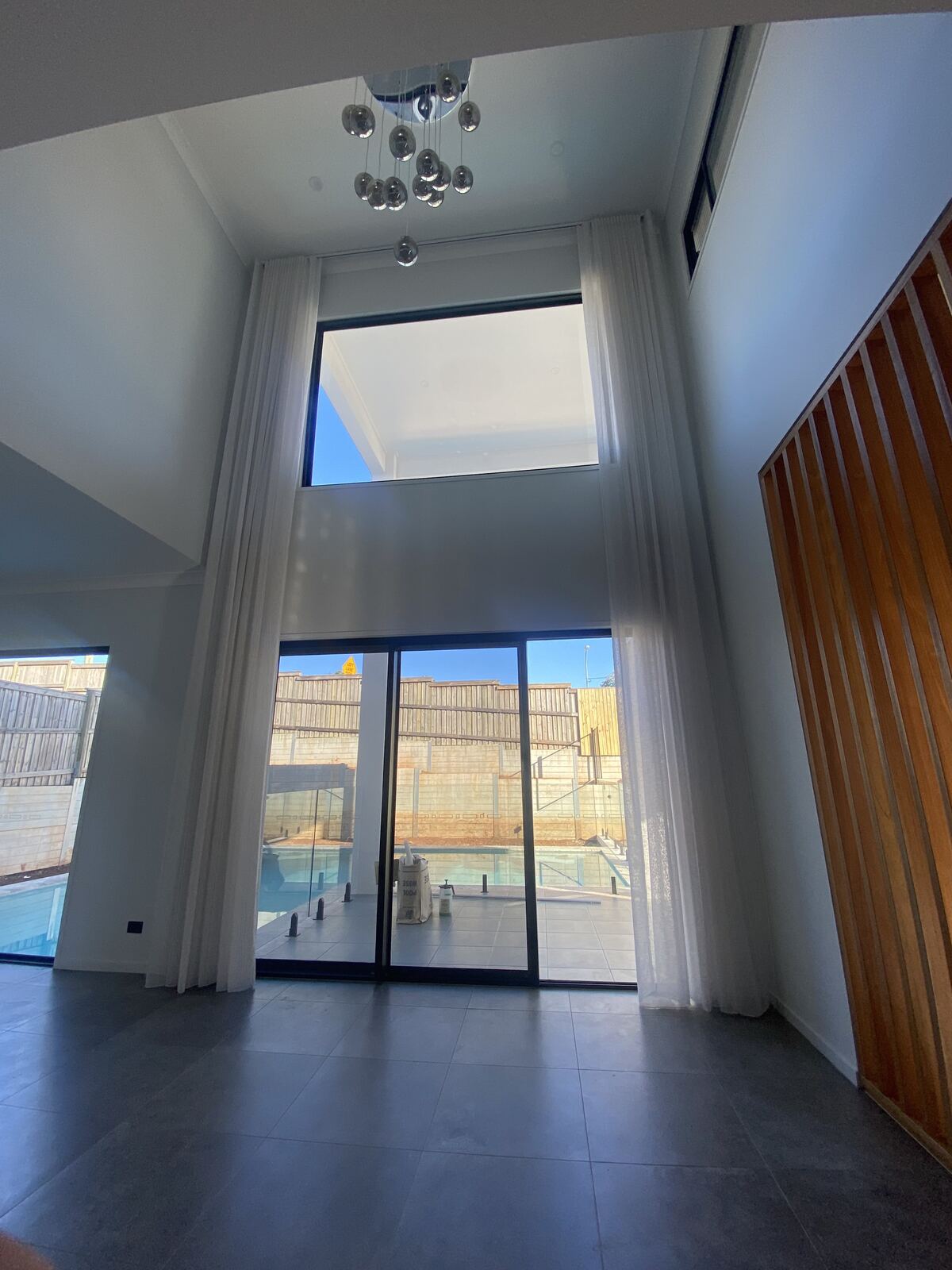 Floor-to-ceiling sheer curtains in a double-height void