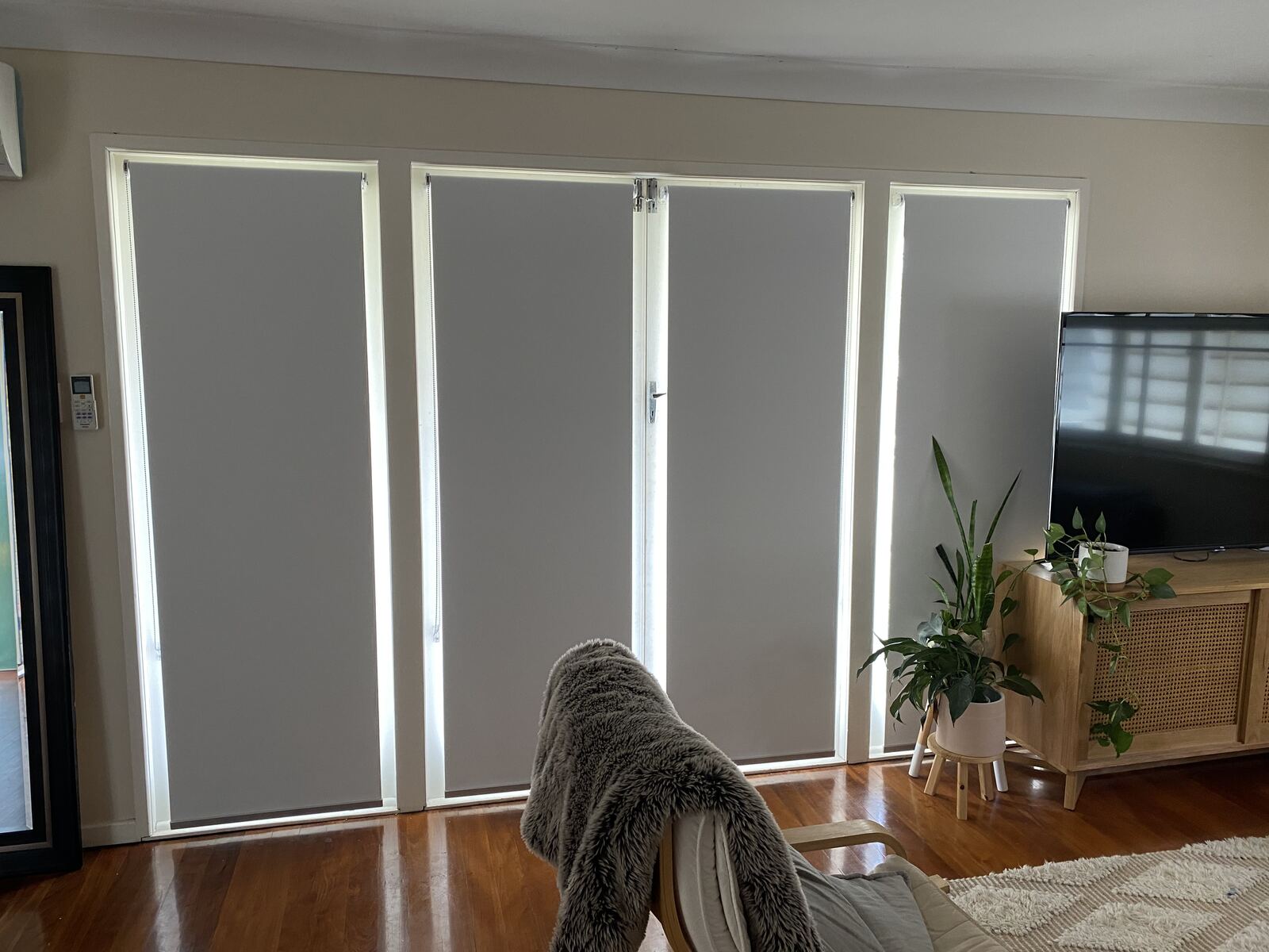Blockout roller blinds on glass doors in a living room