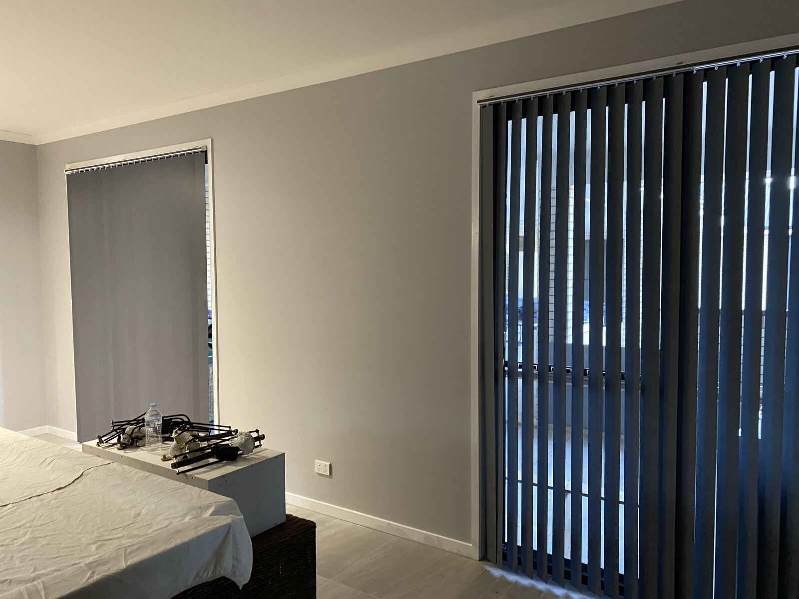 Vertical blinds on a sliding door in a bedroom